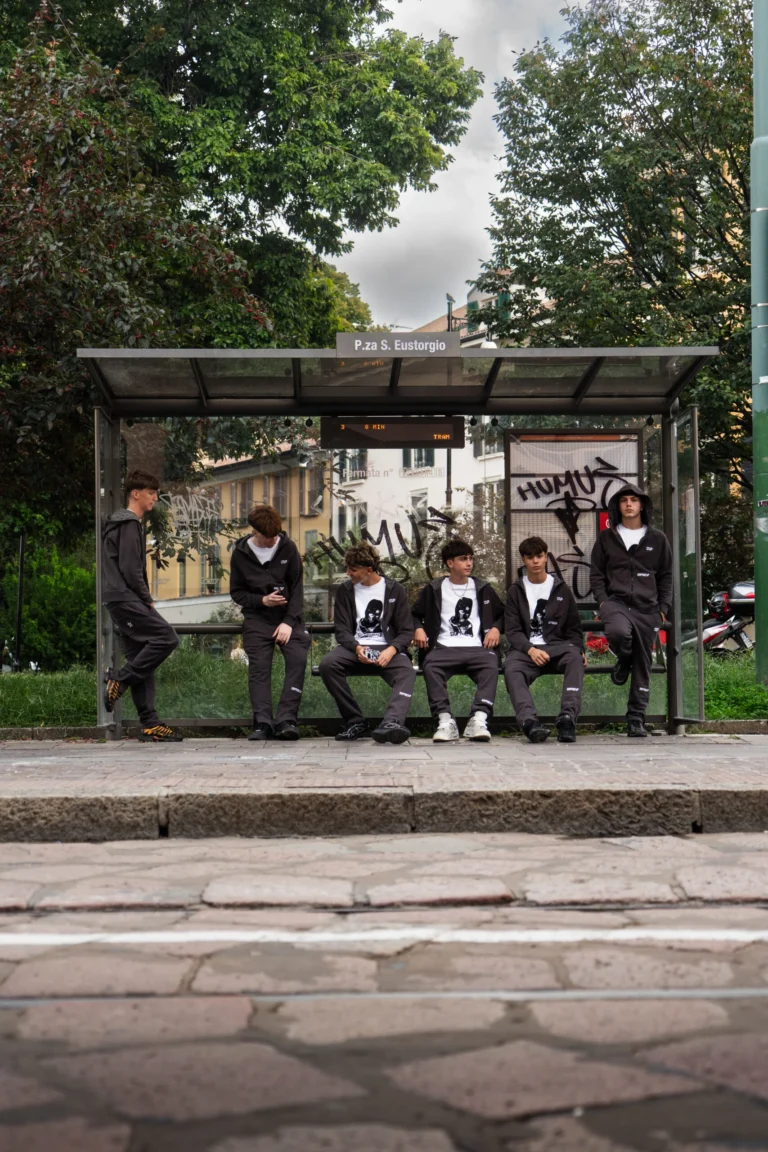 Group wearing LOOP at a bus stop