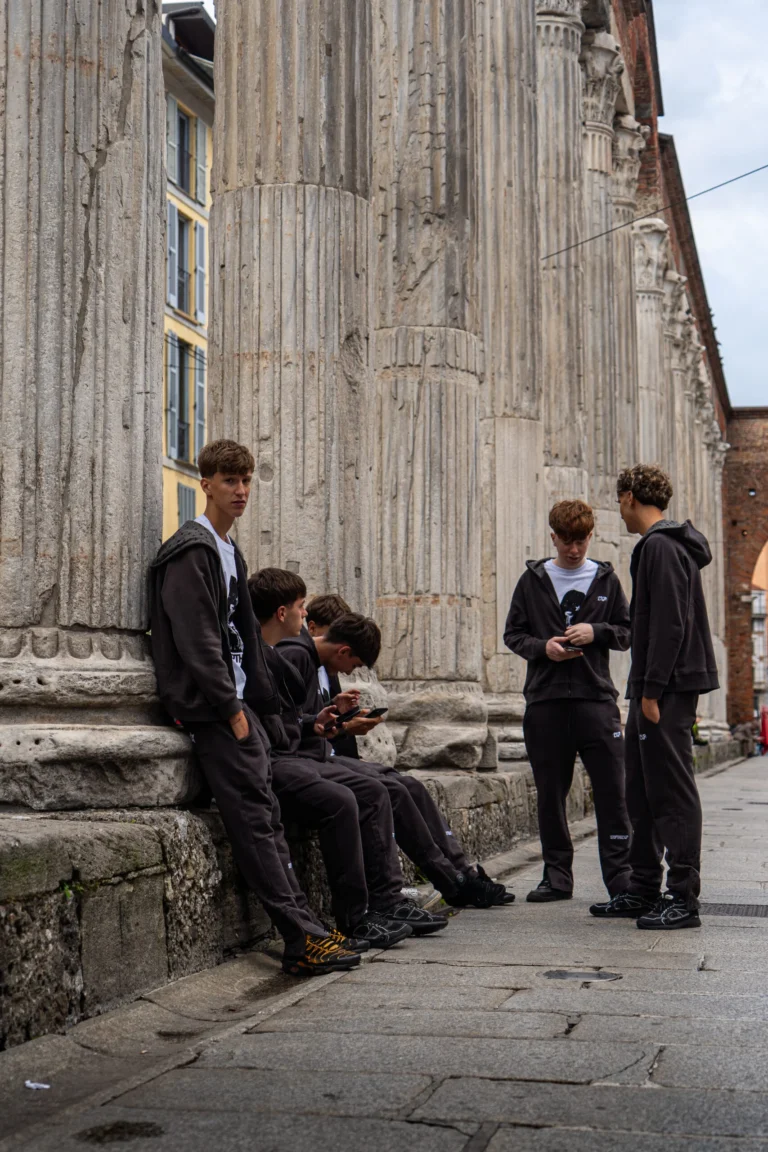 Group in LOOP tracksuits on the steps of a colonnade