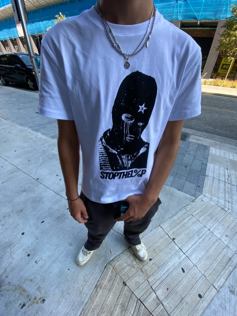 Model wearing the Bandit Tee in white, street setting