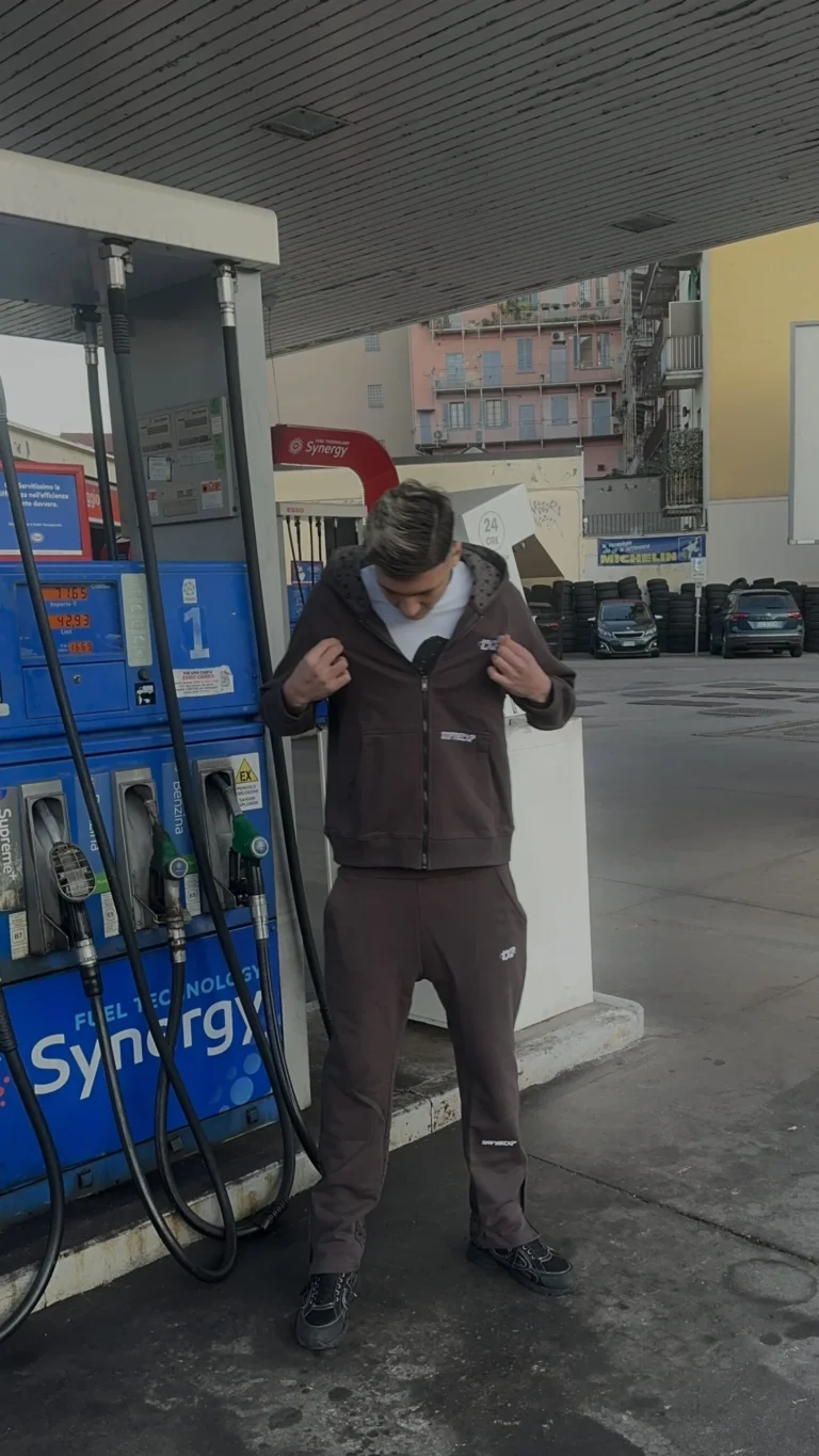 Model wearing the Stars Tracksuit at a petrol station