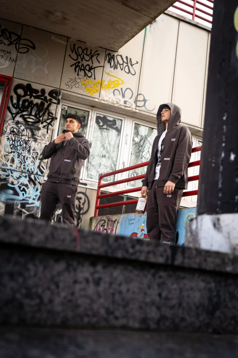 Two models in Stars Tracksuits against a graffiti wall